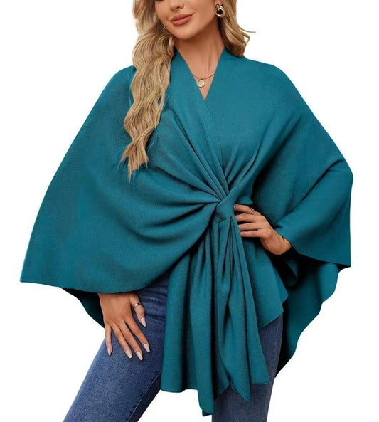 Model wearing peacock blue V-neck shawl cape jacket with loose wrap design – perfect for all seasons.